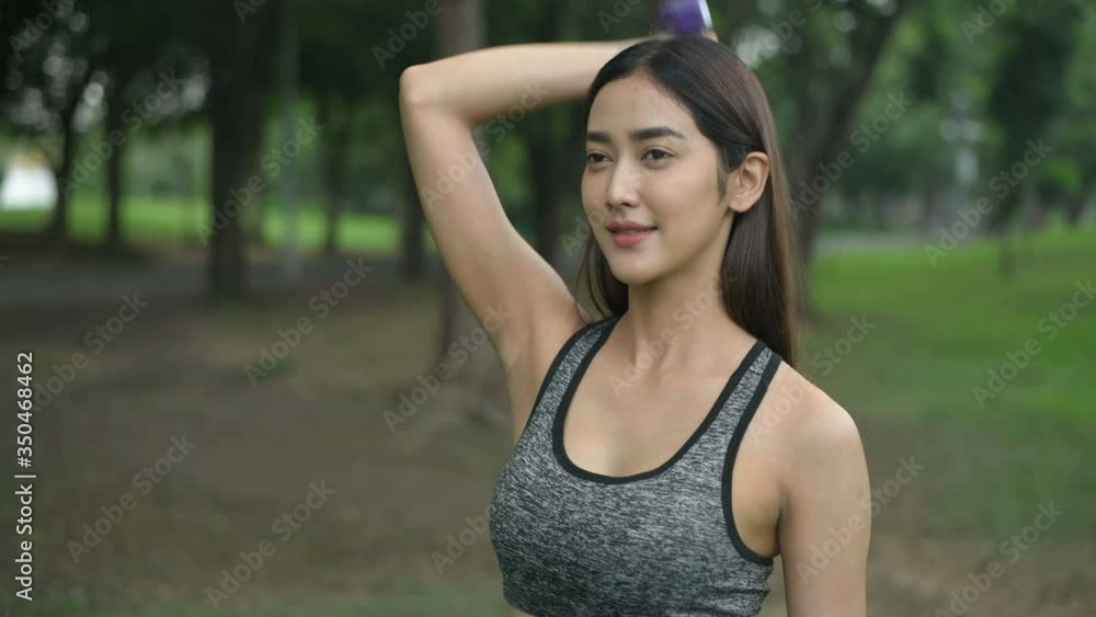 Holiday concept. Young women practicing lifting dumbbells in the garden. 4k Resolution. Holiday concept. Young women practicing lifting dumbbells in the garden. 4k Resolution.