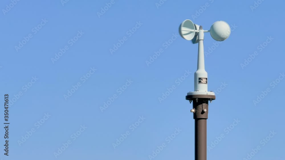 A turning windvane on top of the tower in Kurobe Japan A turning windvane on top of the tower in Kurobe Japan
