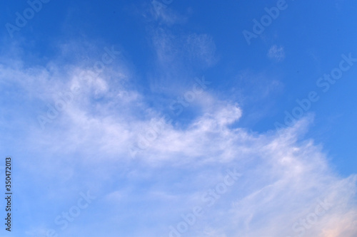 Sky blue background. Natural background.The sky with clouds and sunlight © Chuttapon