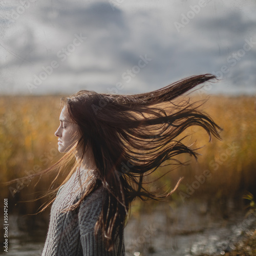 Side view of teenage girl standing in field