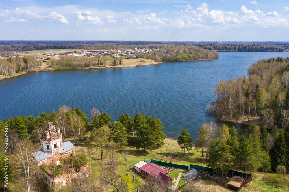 View from the drone of a half-dispersed church on the banks of the Uvodsky reservoir, Egoriy village, Ivanovo region, Russia.