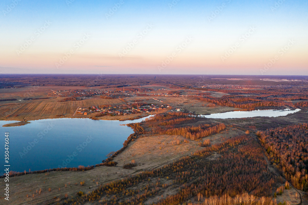 View from the drone of the Uvodsky reservoir in the rays of the setting sun, Russia.