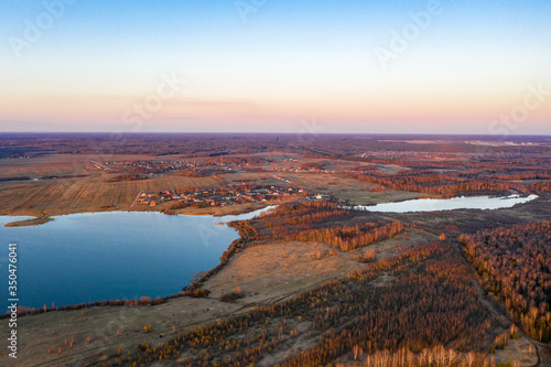 View from the drone of the Uvodsky reservoir in the rays of the setting sun, Russia.