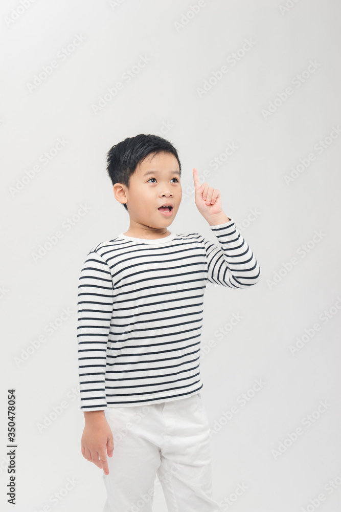 Close up portrait of cute boy pointing with finger gesture, isolated on white background Close up portrait of cute boy pointing with finger gesture, isolated on white background