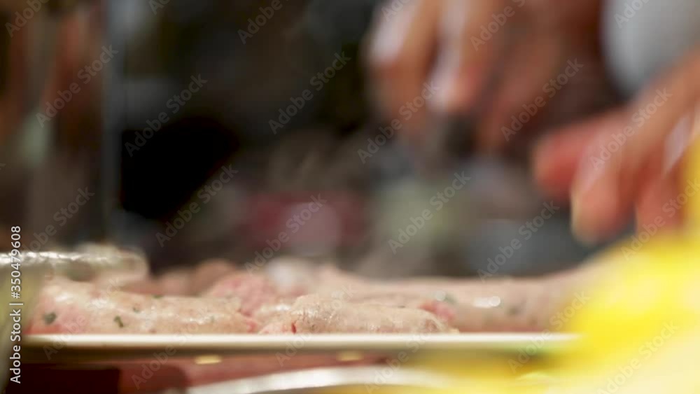 Woman cutting meat n the kitchen. Woman cutting meat n the kitchen.