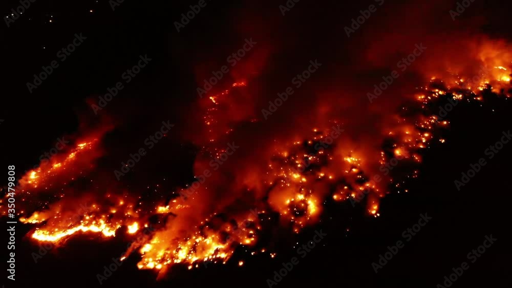 Aerial view of a Siberian wild fire, red inferno flames, forest burning to the ground at night time, in Siberia, Russia - orbit, drone shot Aerial view of a Siberian wild fire, red inferno flames, forest burning to the ground at night time, in Siberia, Russia - orbit, drone shot