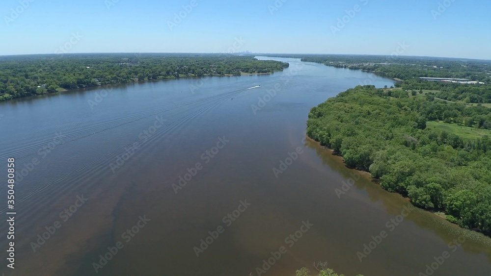 Bird's eye view of a winding river and trees on either side. Bird's eye view of a winding river and trees on either side.
