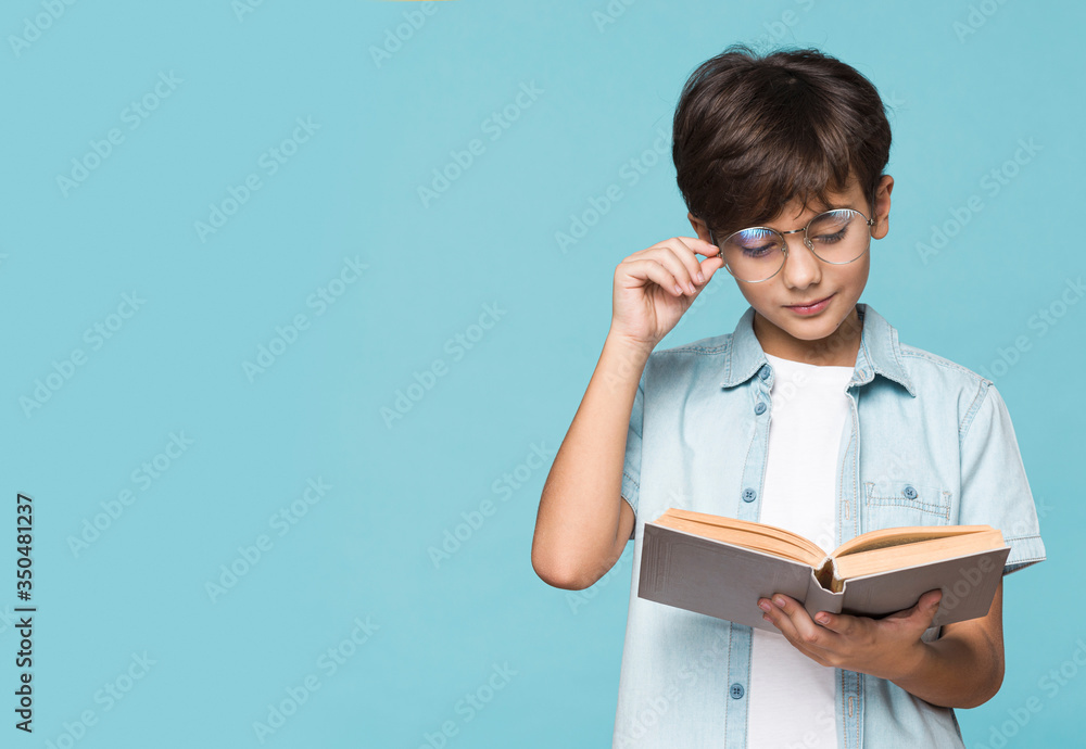 Boy with glasses reading time