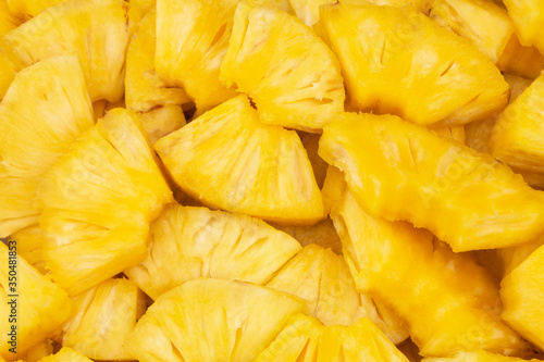 Many juicy pineapple slices as background
