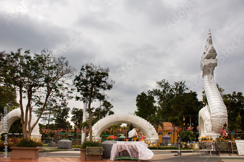 Big white naka statue for thai people travelers travel visit and respect praying at Kaeng kabao canyon at maekong riverside on October 12, 2019 in Mukdahan, Thailand photo