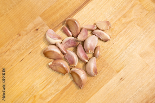 Heap of garlic on wooden background