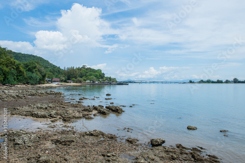 Abstract stone on the beach with mountain landscape