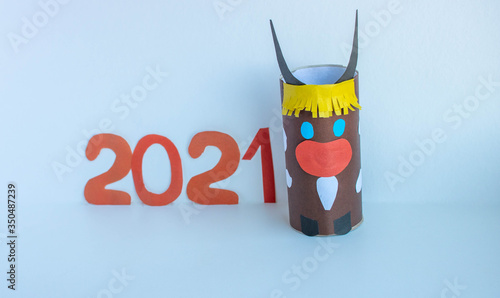 The brown bull. Red numbers 2021.Chinese New year of the white bull. Funny Halloween cute diy monster. photo