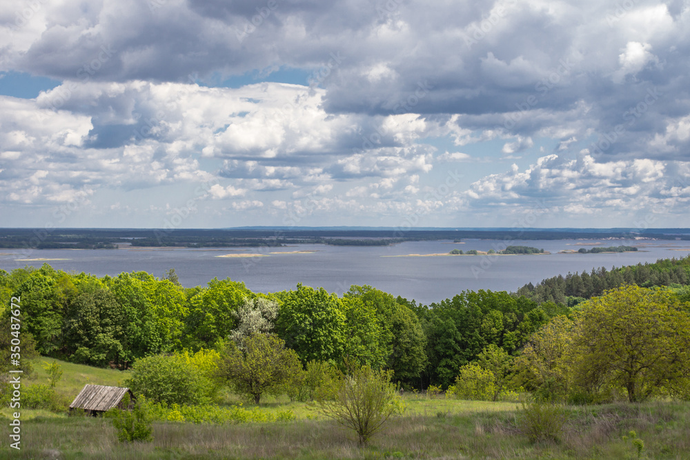 The beauty of Ukrainian nature. Traveling in Ukraine. Breathe clean air. Rest in the country away from noise. Alone with nature. View of the Dnieper River in the Kiev region. Rural landscape.