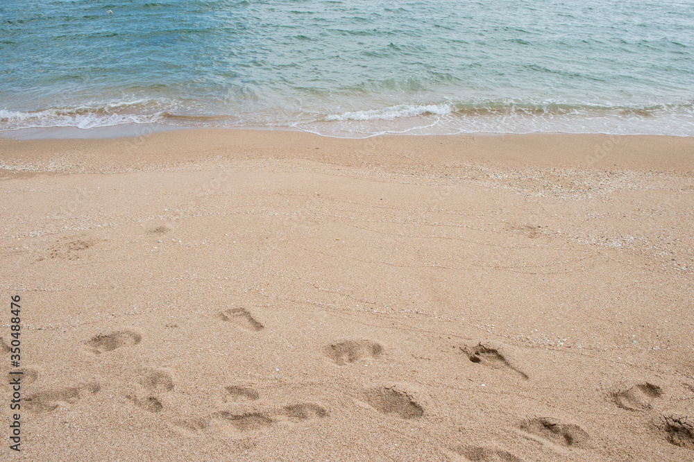 Background of footprint on the beach with sea wave Background of footprint on the beach with sea wave