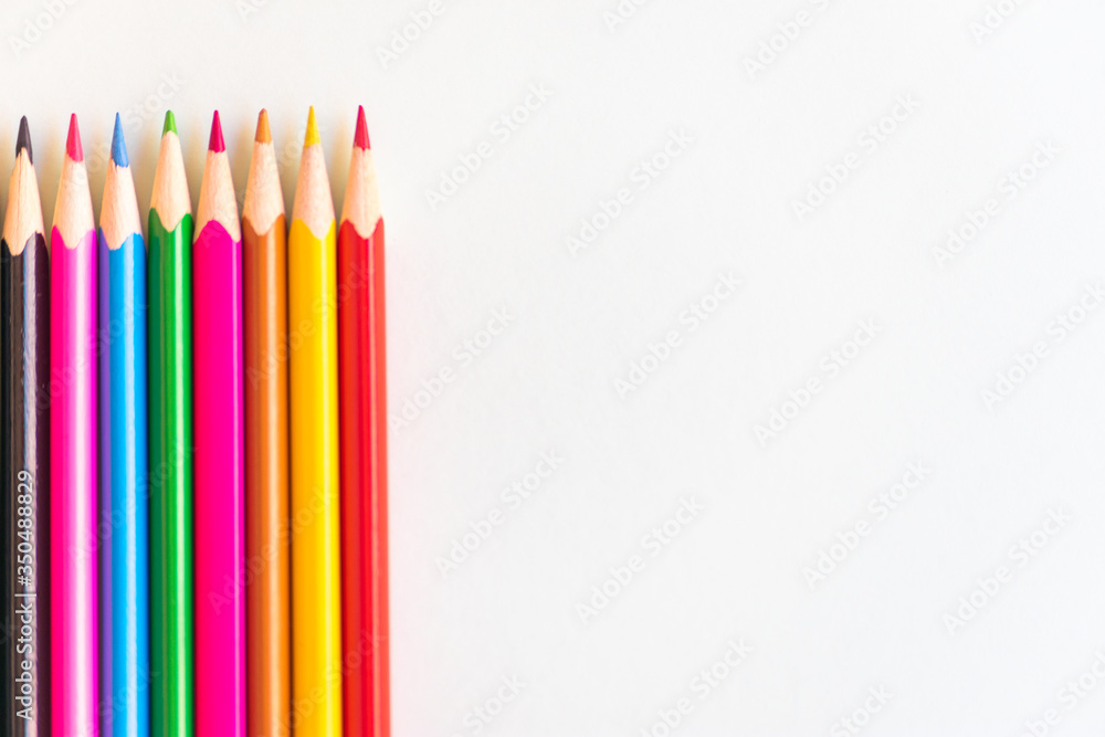 color pencils vertically aligned on white background