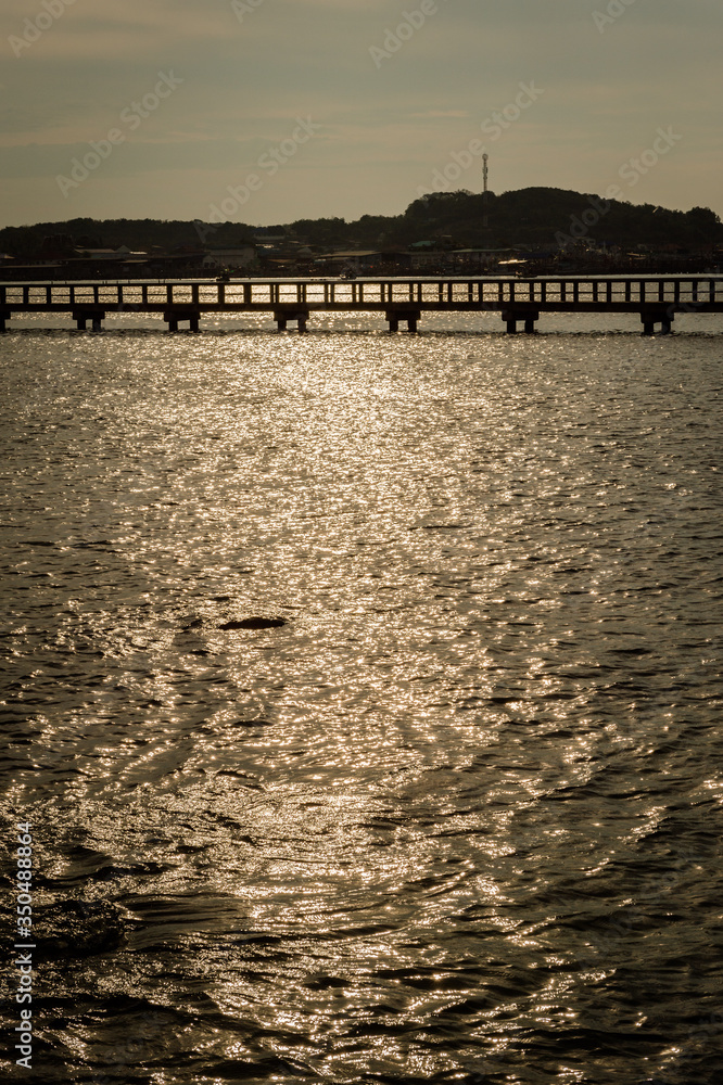 Landscape of sunlight reflection on the sea with bridge