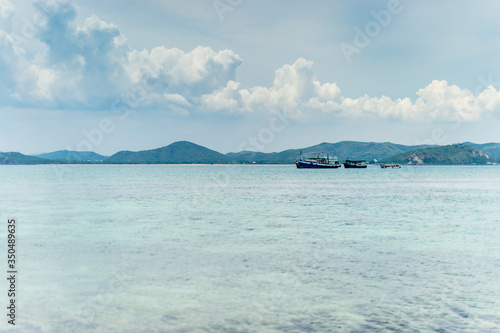 Closeup of boat on the beach with mountain island