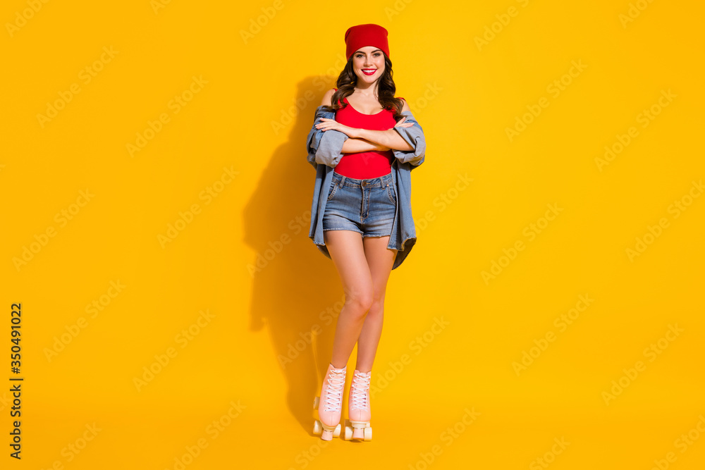 Full size photo of positive cheerful fit street style millennial girl cross hands enjoy roller skates ride rest wear red headwear jeans tank-top isolated over bright color background Full size photo of positive cheerful fit street style millennial girl cross hands enjoy roller skates ride rest wear red headwear jeans tank-top isolated over bright color background