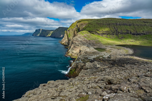 Steep coast in Faroe Islands with large boulders