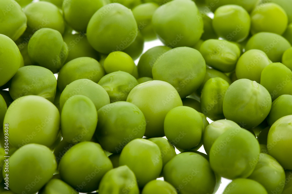Green peas isolated on a white background close-up. Green peas isolated on a white background close-up.