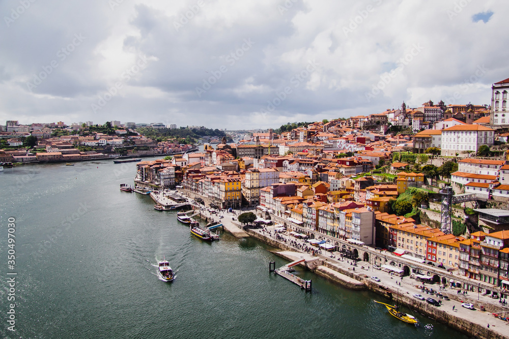 Panoramic view of colorful old houses of Porto, Portugal from metal arch bridge over Douro River(Luis I Bridge). Porto, Portugal.