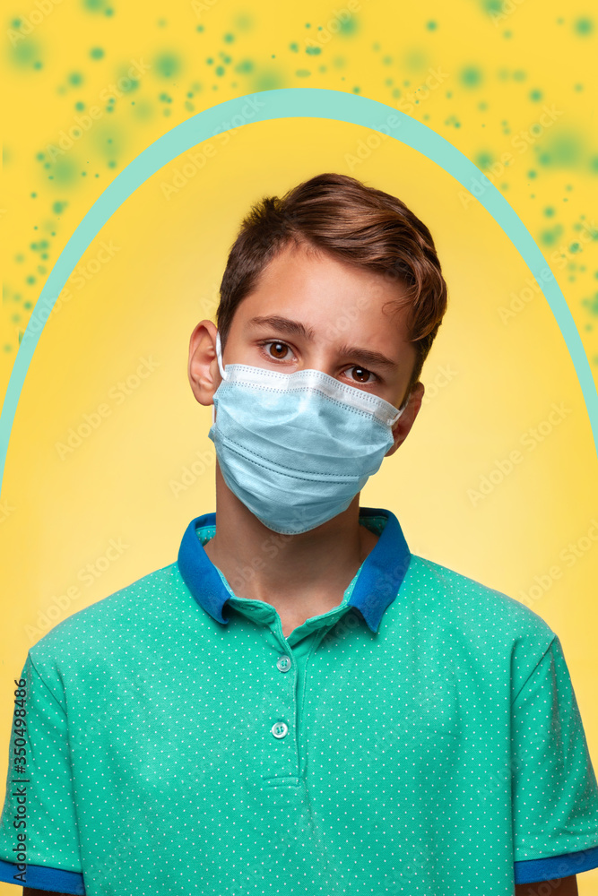 The concept of protection against viruses and diseases. A teenager in a blue t-shirt and mask stands on a yellow background. Around it is a protective oval from bacteria. Vertial The concept of protection against viruses and diseases. A teenager in a blue t-shirt and mask stands on a yellow background. Around it is a protective oval from bacteria. Vertial