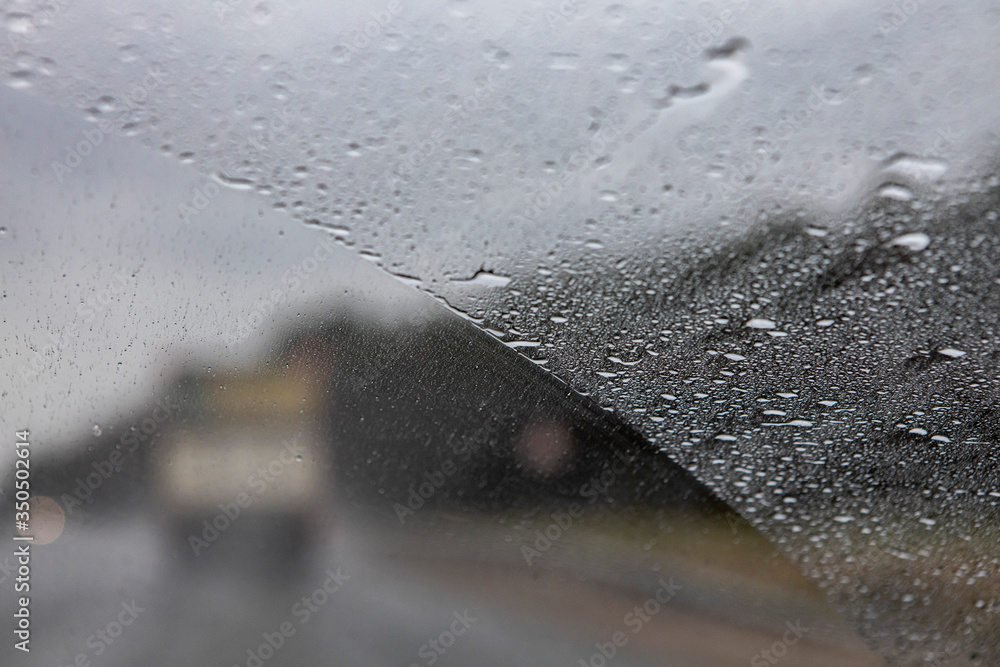 the view from the window of a moving car in rainy weather. Defocused track and cars. Speed in poor visibility conditions - obrazy, fototapety, plakaty 