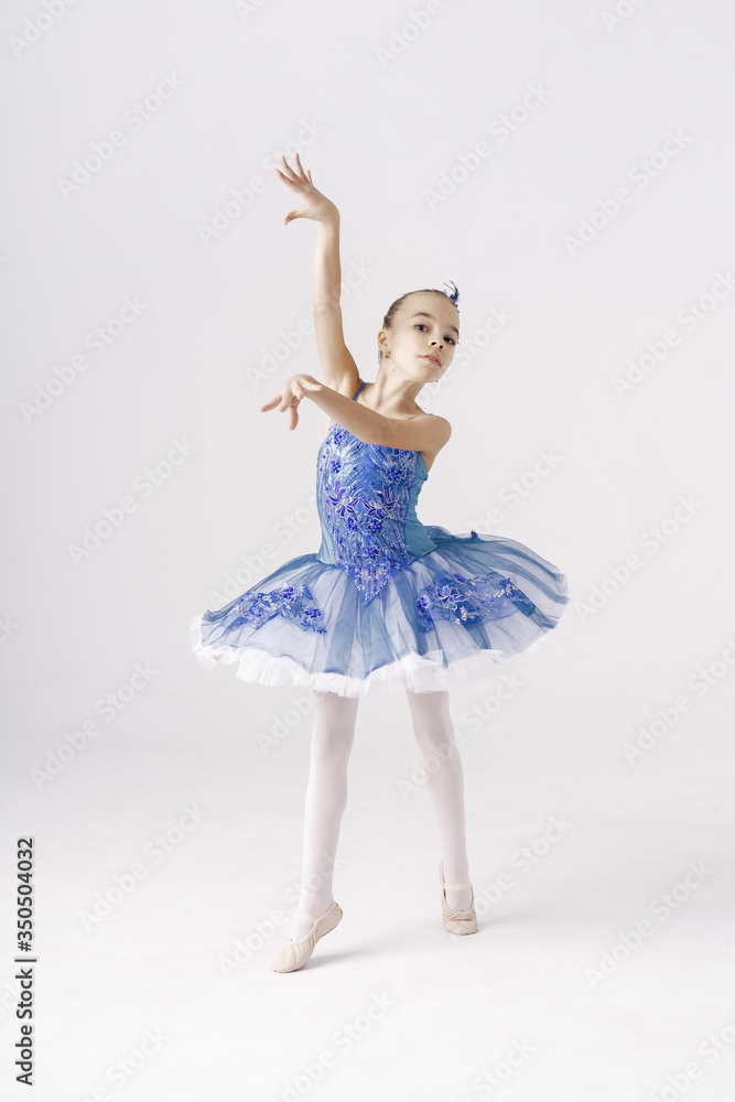 Beautiful preteen girl ballerina wearing a princess dress, winter fairy dancing over white background Beautiful preteen girl ballerina wearing a princess dress, winter fairy dancing over white background