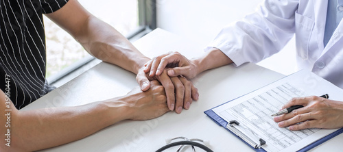 Doctor touching patient hand for encouragement and empathy
