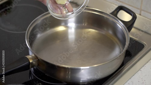 Pouring butter into the hot pan photo