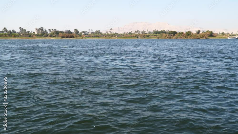 The coast of the Nile River in Luxor, Egypt. View from a floating boat. The coast of the Nile River in Luxor, Egypt. View from a floating boat.
