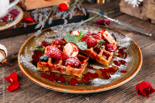 Dessert Belgian waffles with berries and sauce