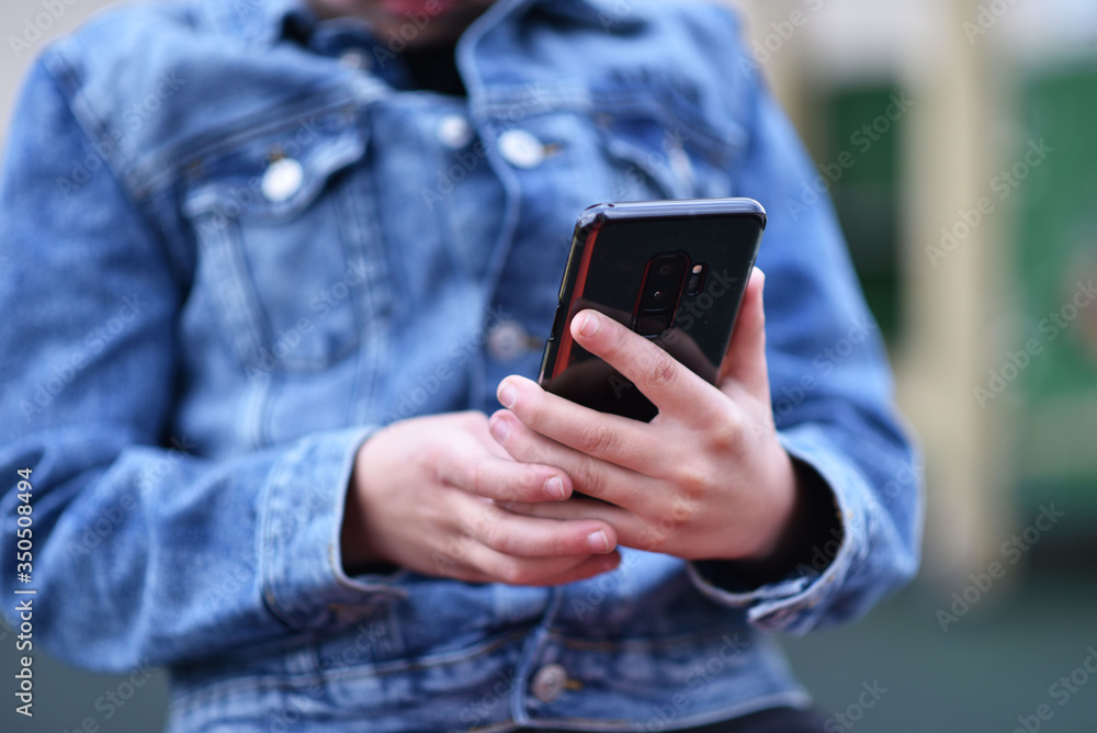 Closeup of Teenager holding a phone in his hand