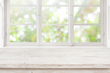 Vintage wooden table on blurred window background for product display