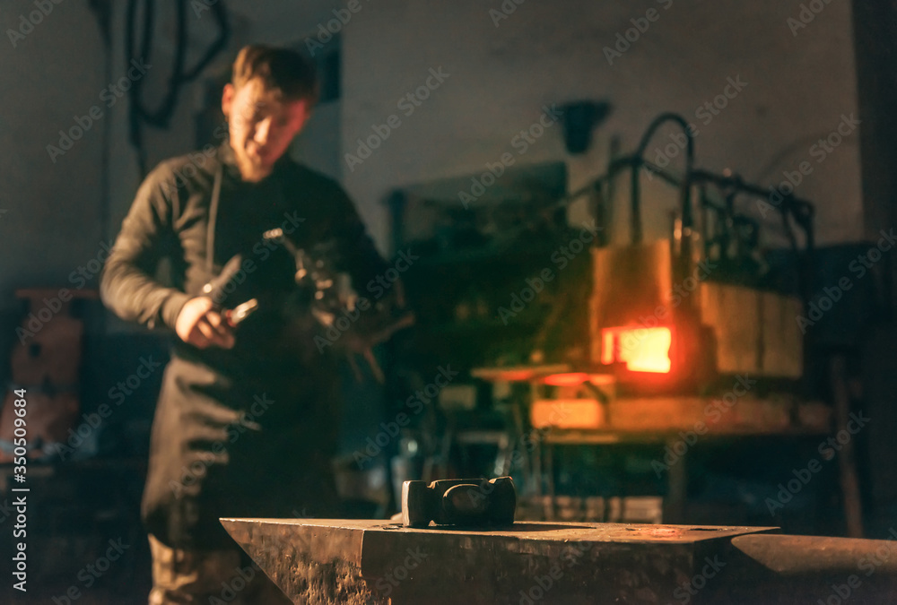 Blacksmith man working in forge. Blacksmith man working in forge.