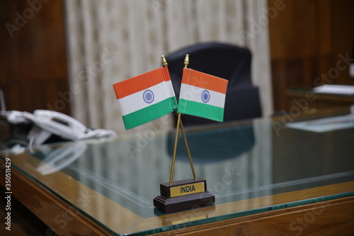 Allahabad, Uttar Pradesh/India- May 16 2020: Indian tricolor flag placed on the big table of a government officer.