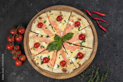 Italian pizza with tomatoes on a black background