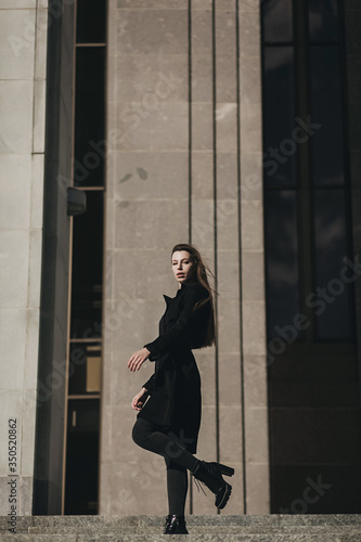fashionable woman in black coat