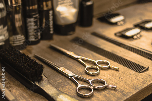 Canvas Print professional scissors and combs lie on a shelf in a hairdresser
