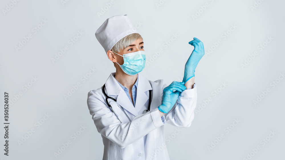 Doctor is ready to examine patient. Woman puts on protective mask and gloves Doctor is ready to examine patient. Woman puts on protective mask and gloves