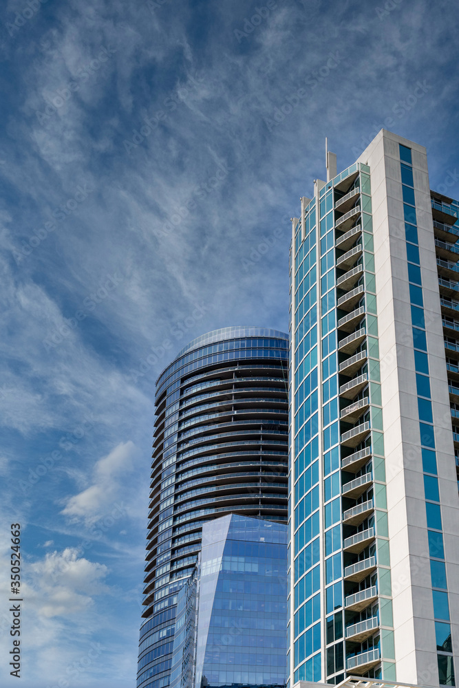 Fototapeta premium Two Modern Blue Glass and Steel Towers on Blue Sky