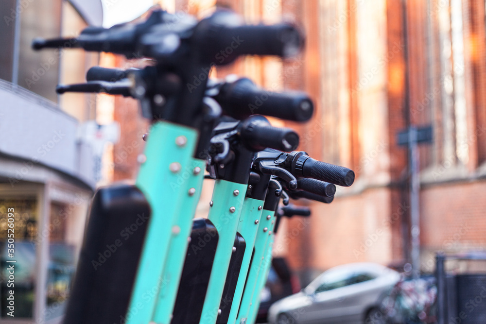 Foto de Escooters or electric scooters are lined up in a row on the