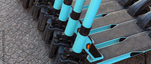 Wallpaper Mural E-scooters or electric scooters are lined up in a row on the street corner in a big city e-mobility e-scooter mobile office means of transport environmentally friendly alternative new cityscape Torontodigital.ca