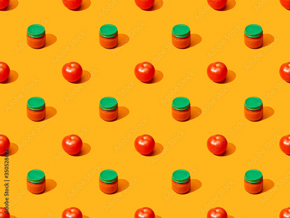 fresh tomatoes and puree in glass jars on orange colorful background, seamless pattern fresh tomatoes and puree in glass jars on orange colorful background, seamless pattern