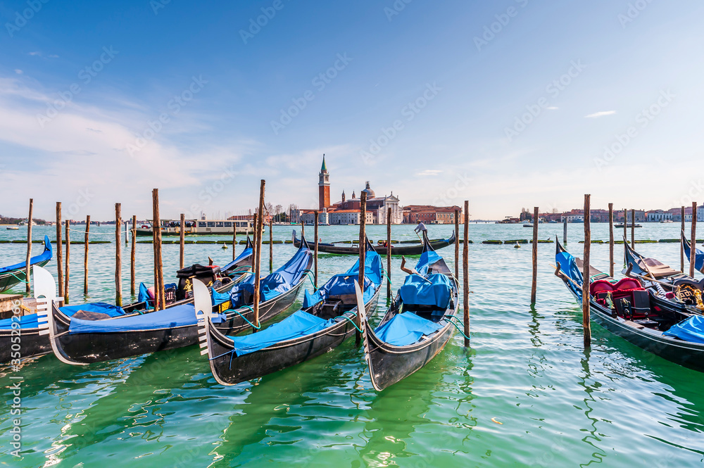 Gondolas and San Giorgio Maggiore Island in the background in the Venice Lagoon in Veneto, Italy
