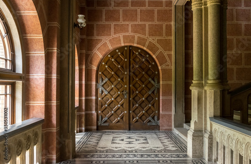 Chernivtsi city  Bukovina  Ukraine - June 12  2018   ancient wrought-iron door and a marble staircase in the lobby of the old university building in the city of Chernivtsi. Medieval architecture