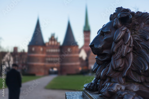 Принти на полотні Holstentor in Lübeck with lion statue in the foreground UNESCO World Heritage Si