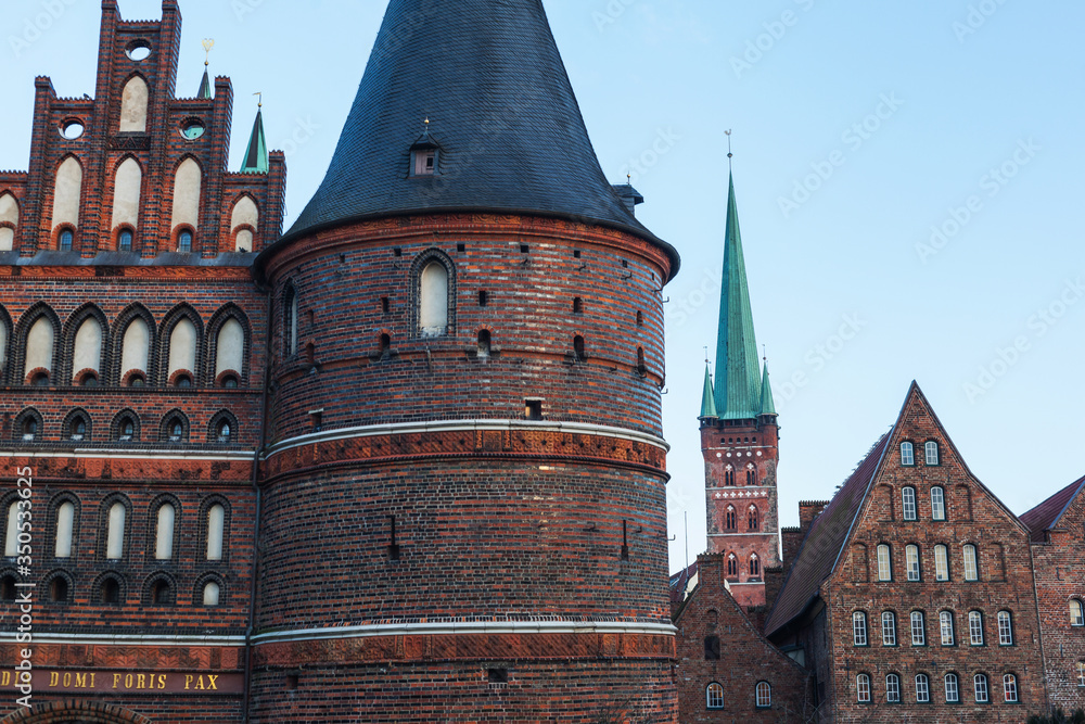 Front view of Holstentor in Lübeck towards the sky UNESCO World Heritage Site landmark Gothic historic cityscape ornaments restored brick