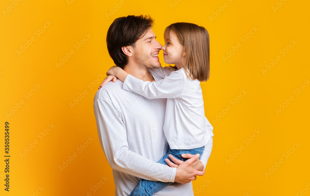 Warm portrait of cute little girl looking at her daddy Warm portrait of cute little girl looking at her daddy